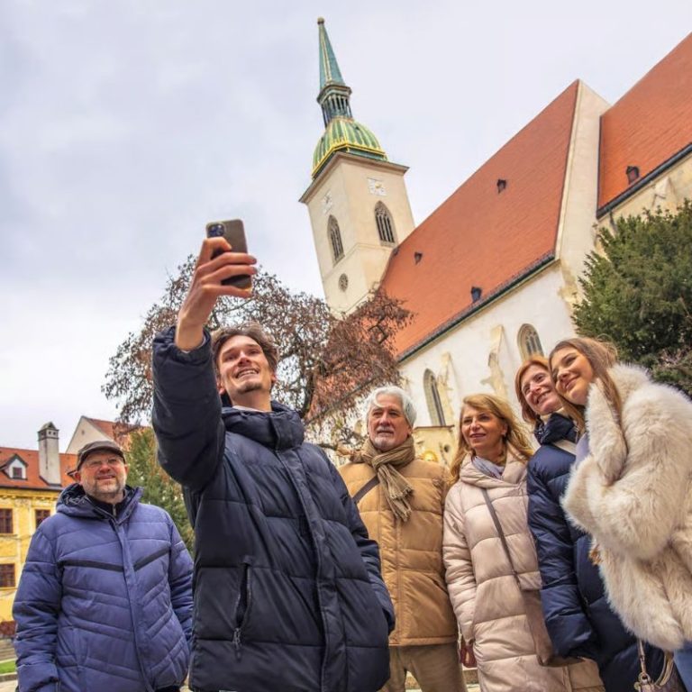 Tour guide showing historical landmarks during Bratislava city tour.