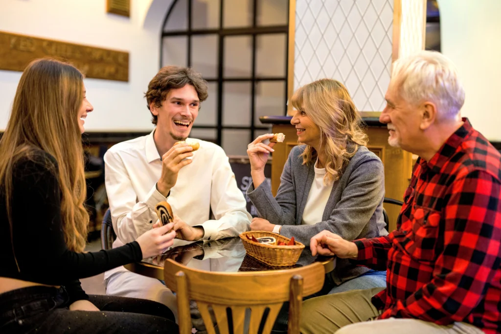 Tourists tasting fresh local pastries at a traditional bakery in Bratislava.