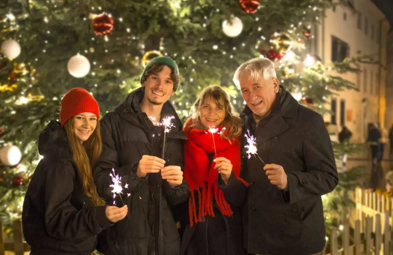 Smiling guests holding sparklers at the Bratislava Christmas markets
